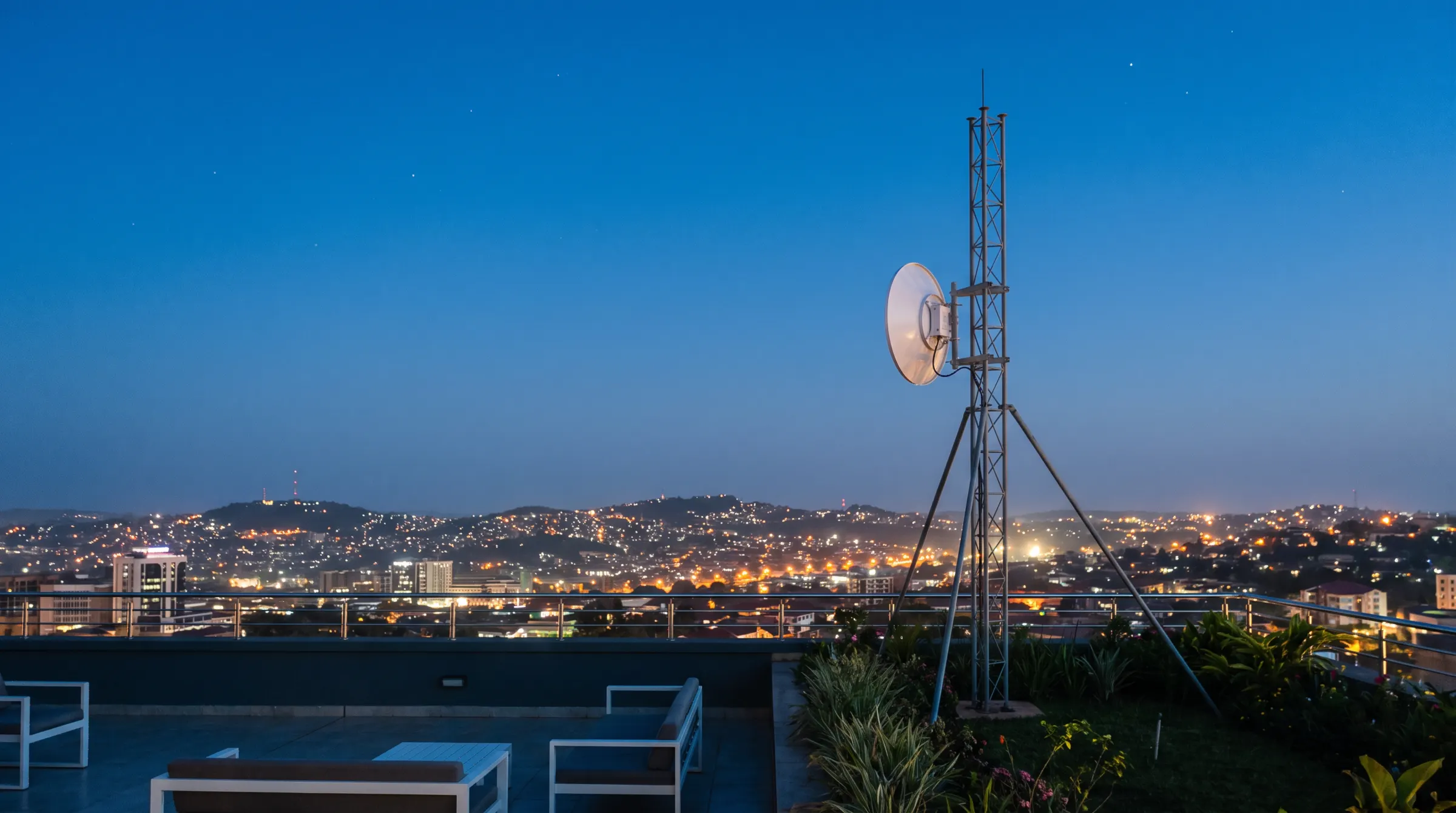 A point-to-point wireless dish on a Kampala rooftop at dusk